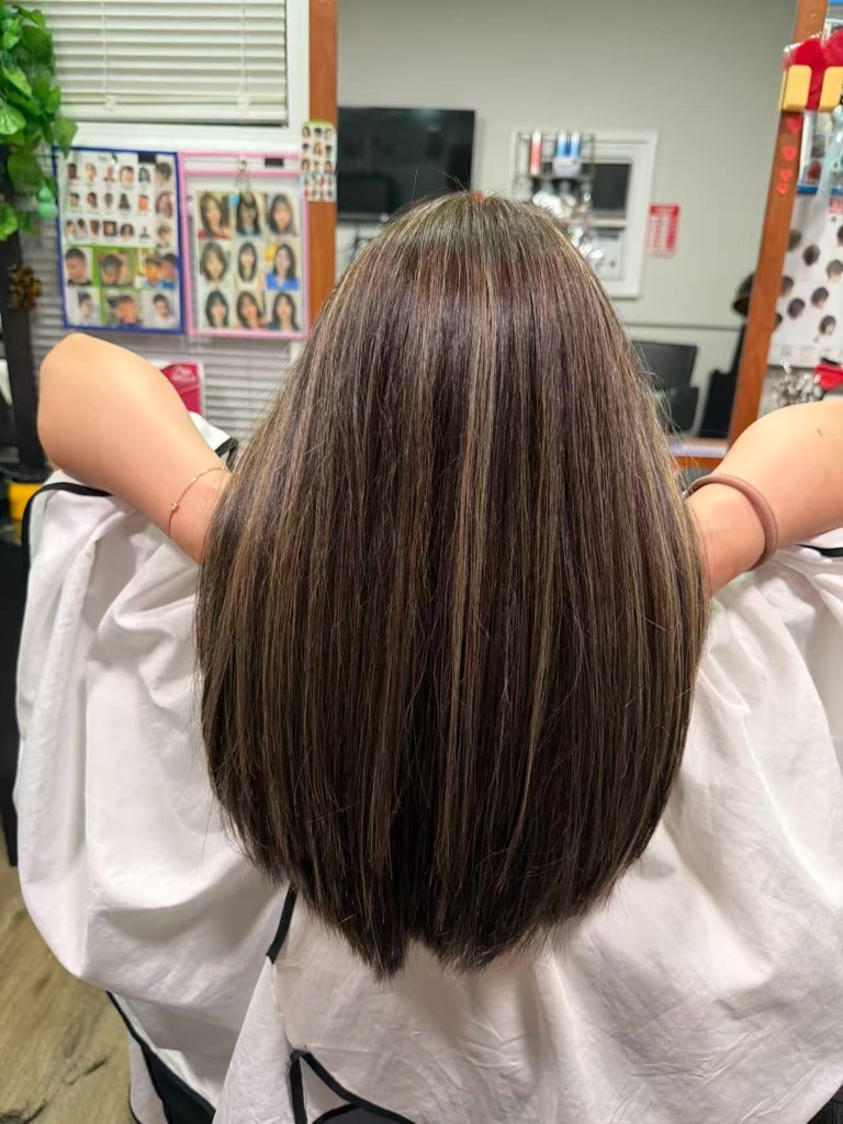 Shoulder-length brown hair with fine blonde highlights and a blunt cut at Simple Cuts Framingham by Hannah