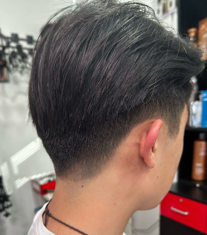 Men's cut with a longer textured top and a tapered back at Simple Cuts Framingham by Hannah