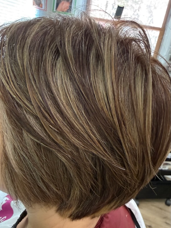 Short stacked bob with blonde and caramel highlights at Simple Cuts Framingham by Hannah